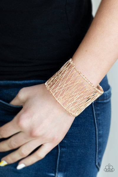 Wire after wire crisscrosses across the wrist, coalescing into an edgy cuff. Sold as one individual bracelet.  P9IN-GDRS-079XX